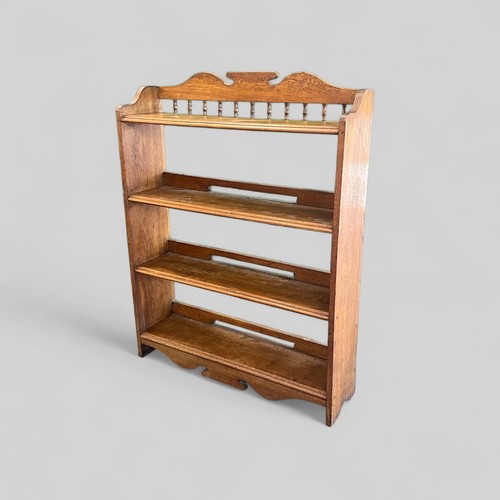 141 - Oak open bookshelf with raised decorative gallery above, measures approx. 88cmW x 24cmD x 112cmH