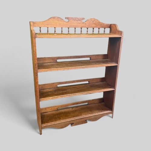 141 - Oak open bookshelf with raised decorative gallery above, measures approx. 88cmW x 24cmD x 112cmH