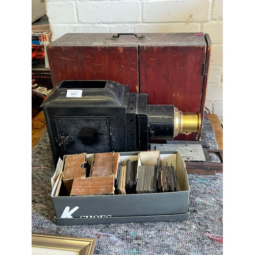 136A - Cased magic lantern together with a selection of slides, mostly cartoon pictures