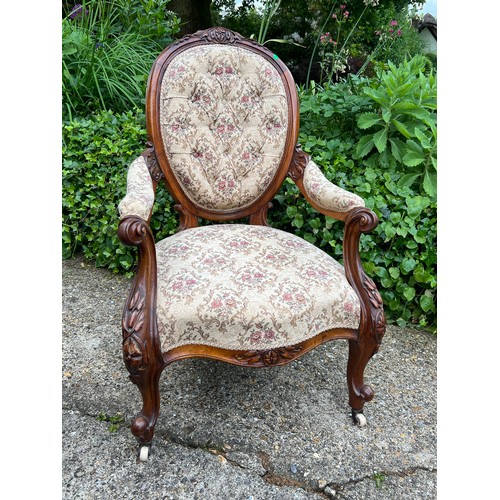 580 - Antique upholstered armchair with exposed carved top and handles