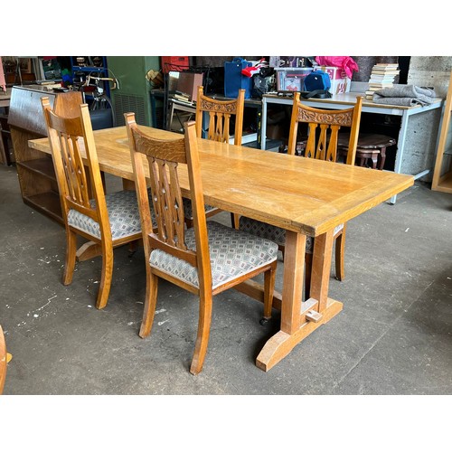 116 - A long light oak refractory style table together with four upholstered arts and crafts style dining ... 