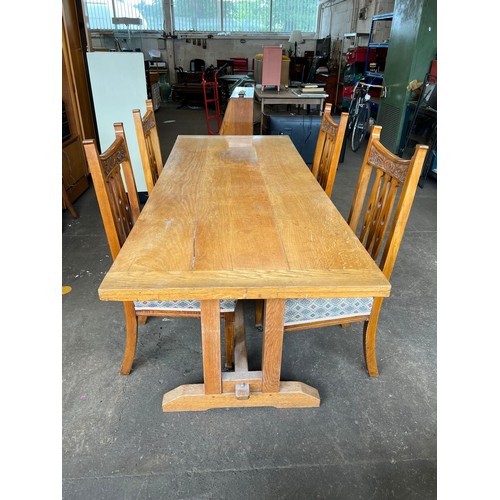 116 - A long light oak refractory style table together with four upholstered arts and crafts style dining ... 