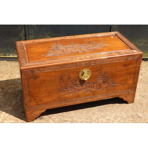 188 - Camphor wood chest with oriental carved front, sides and top measures approx. 94cmW x 46cmD x 50cmH