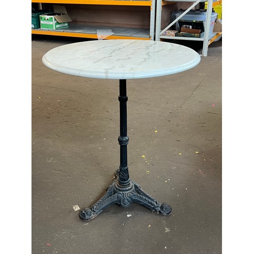 47 - Marble topped circular table on cast base measures approx. 60cm diameter