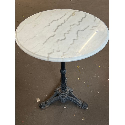 47 - Marble topped circular table on cast base measures approx. 60cm diameter