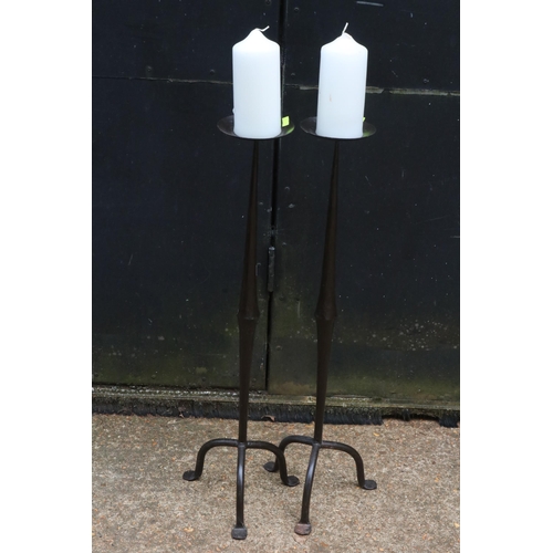 172 - A pair of heavy cast iron candle stands with candles