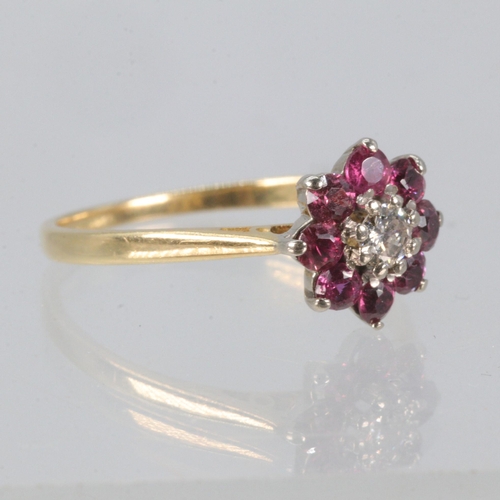 162 - 18ct gold ring with central diamond surround by 8 rubies