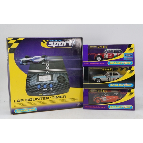 319 - Boxed Scalextric sport lap counter/timer (unchecked) together with 3 boxed Scalextric cars to includ... 