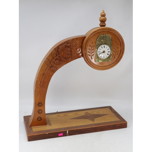 377 - French carriage clock movement and brass face set into a carved wood arch