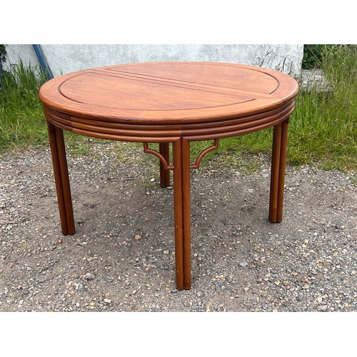 463 - Chinese hardwood dining table, extending with two additional leaves.