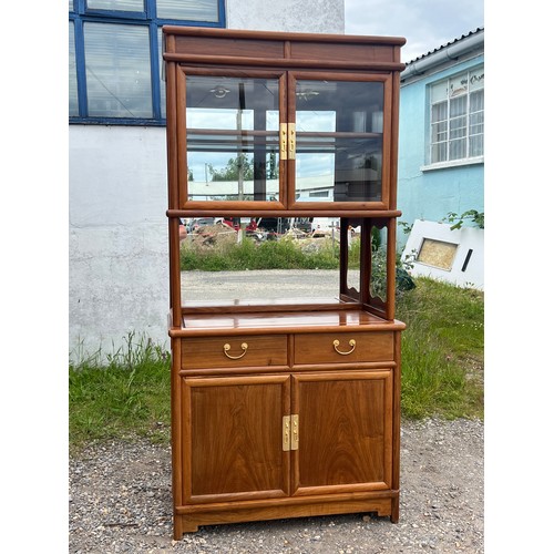 555 - Chinese hardwood display cabinet over cupboard base, fitted adjustable shelves.