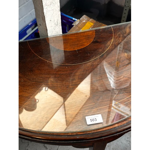 503 - A half moon occasional table with glass top