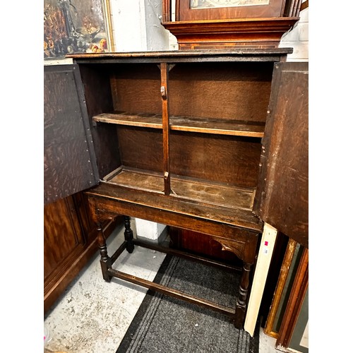 475 - An oak gothic carved cupboard on stand