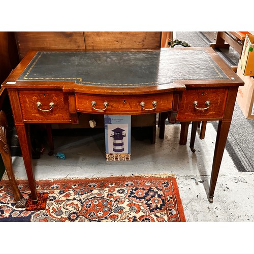 313 - An Edwardian mahogany writing desk with inset leather top with breakfront fitted three drawers on ta... 