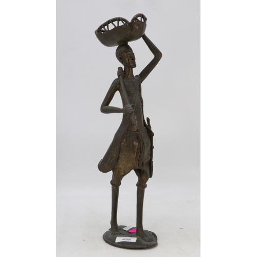 435 - Tall African metal sculpture of a man carrying a basket