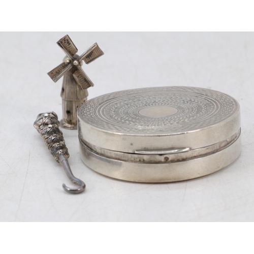 16 - Silver compact, button hook and windmill