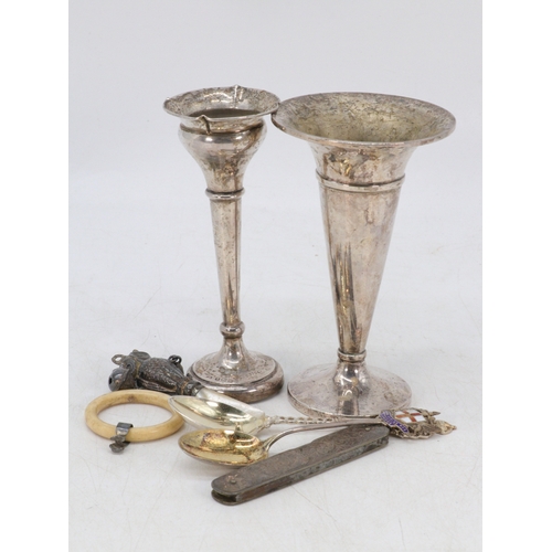 21 - Two weighted silver vases, two silver souvenir spoons, broken silver rattle and silver fruit knife