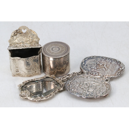 25 - A white metal rouge pot and cover, together with an embossed silver hallmarked nurses buckle, 800 gr... 