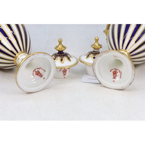55 - A pair of Royal Crown Derby twin handled vases with covers central lozenges with hand painted floral... 