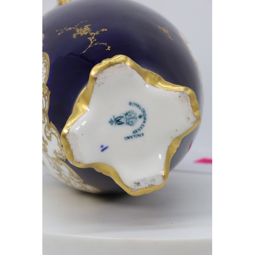 64 - Royal Crown Derby twin handled vase on colbalt blue ground with raised gilt decoration with floral l... 