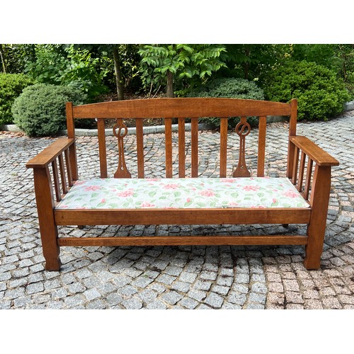 41 - Arts and craft liberty style oak settle with later upholstered seat measures approx. 158cmW x 64cmD