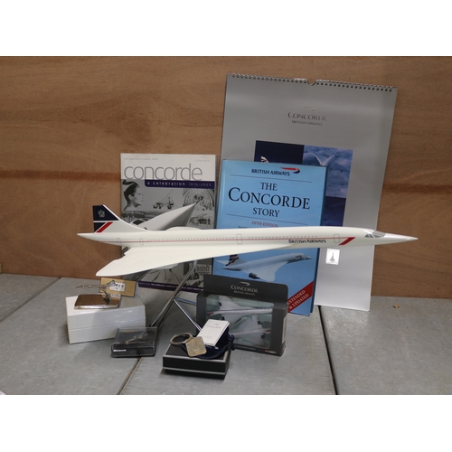 384 - Carton of assorted Concorde related memorabilia including a model on stand.