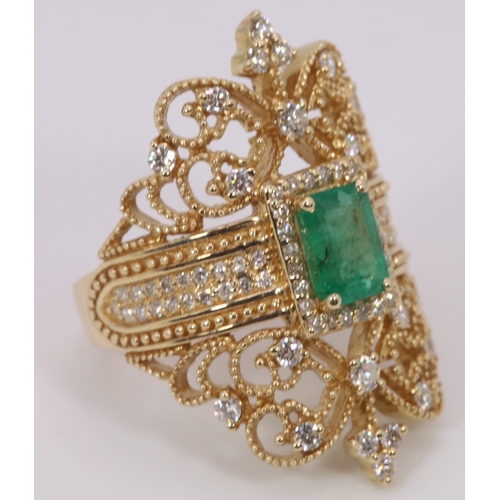 126 - Impressive 14k Gold ring set with centre emerald and surrounded with smaller diamonds.