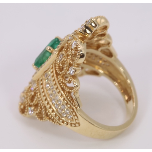 126 - Impressive 14k Gold ring set with centre emerald and surrounded with smaller diamonds.