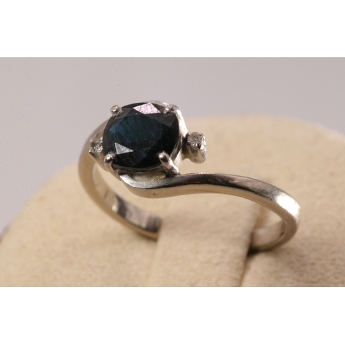 139 - 18ct white gold black sapphire and diamond ring, oval Sapphire 7x6mm approx.