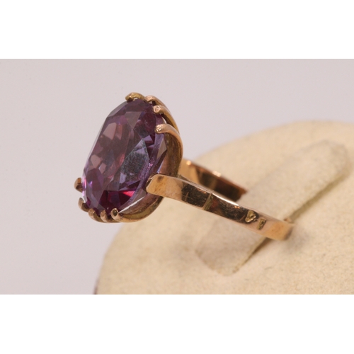 159 - A Sapphire 9ct gold dress ring, oval purple stone, 14mm x 10 mm approx.