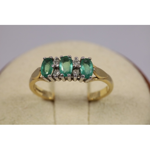 206 - 18ct gold ring set with three green stones (approx. weight 3g)