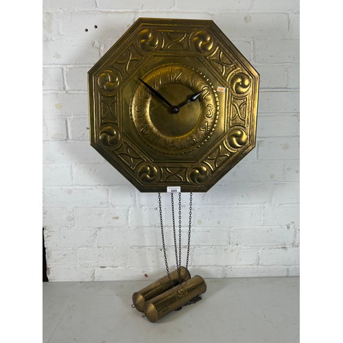 447 - Arts and craft style brass faced wall clock with weights and pendulum