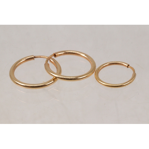 134 - Pair of 18ct gold hoop earrings, also one single smaller one. (18ct weight approx. 1.3g)