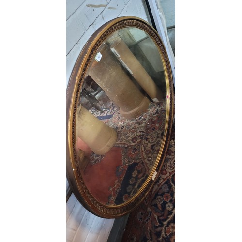 255 - Large oval gilt mirror with bevelled edge