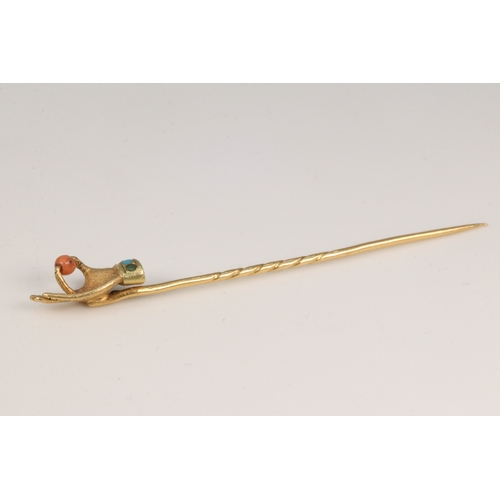 175 - Yellow metal antique tie pin of a handholding a single piece of coral