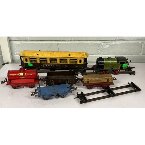 651 - A vintage OO gauge clockwork engine, LNER 460 with a pullman carriage, and four wagons and a quantit... 