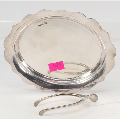 145 - Silver card tray together with a pair of silver sugar tongs in the form of a wishbone (approx 130g)