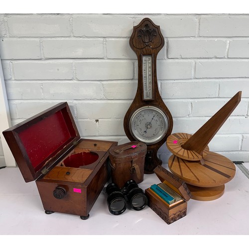 512 - A mahogany tea caddy, oak wall barometer thermometer, wooden sundial, and a cased pair of binoculars