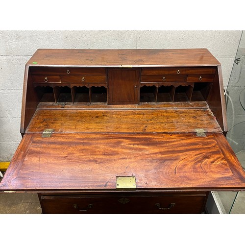 15 - Georgian mahogany bureau with plane slope and four graduated drawers under on bracket feet