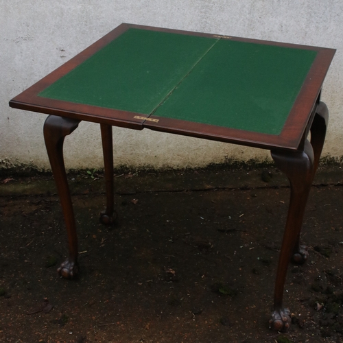 17 - Fold over mahogany card table with ball and claw feet