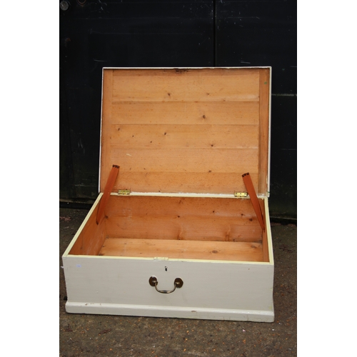 51 - White painted pine storage box on rollers measures approx. 93cmW x 70cmD x 31cmH