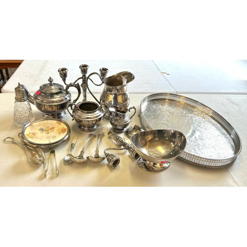 621 - A selection of silver-plated items to include tea set, candlesticks, jug etc