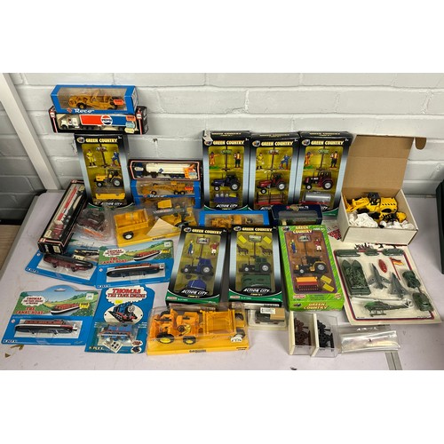 203 - A box of diecast and plastic vehicles to include Ertl Thomas Roco etc