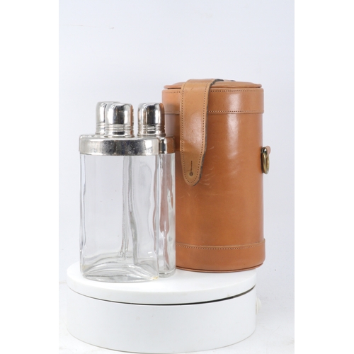 33 - Leather cased decanter set with three fitted bottles