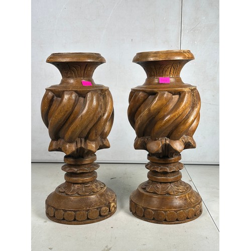 360 - A pair of wooden candlesticks