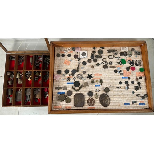 A tabletop display full of artefacts and metal detector finds including ...