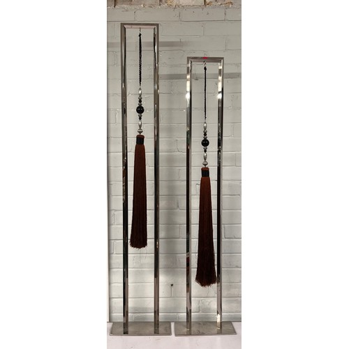 549 - Two stainless steel floor standing decorative pieces