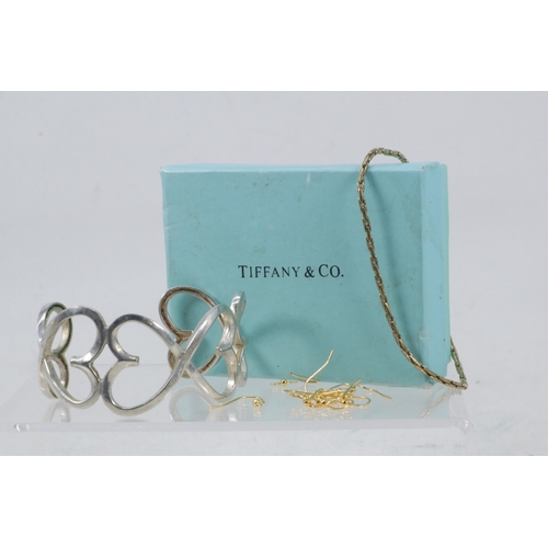 200 - Tiffany? silver bangle together with silver earrings and an unmarked bracelet