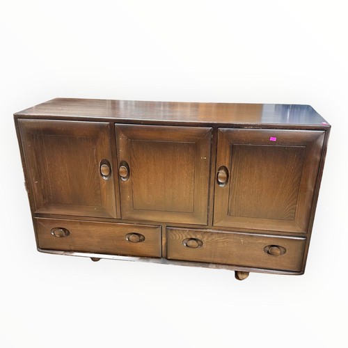 676 - An Ercol sideboard with three cupboards with two drawers under on castors