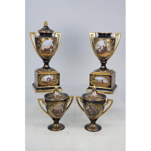 57 - Vienna Porcelain Urns on stands (one missing cover) together with two matching cups with covers all ... 